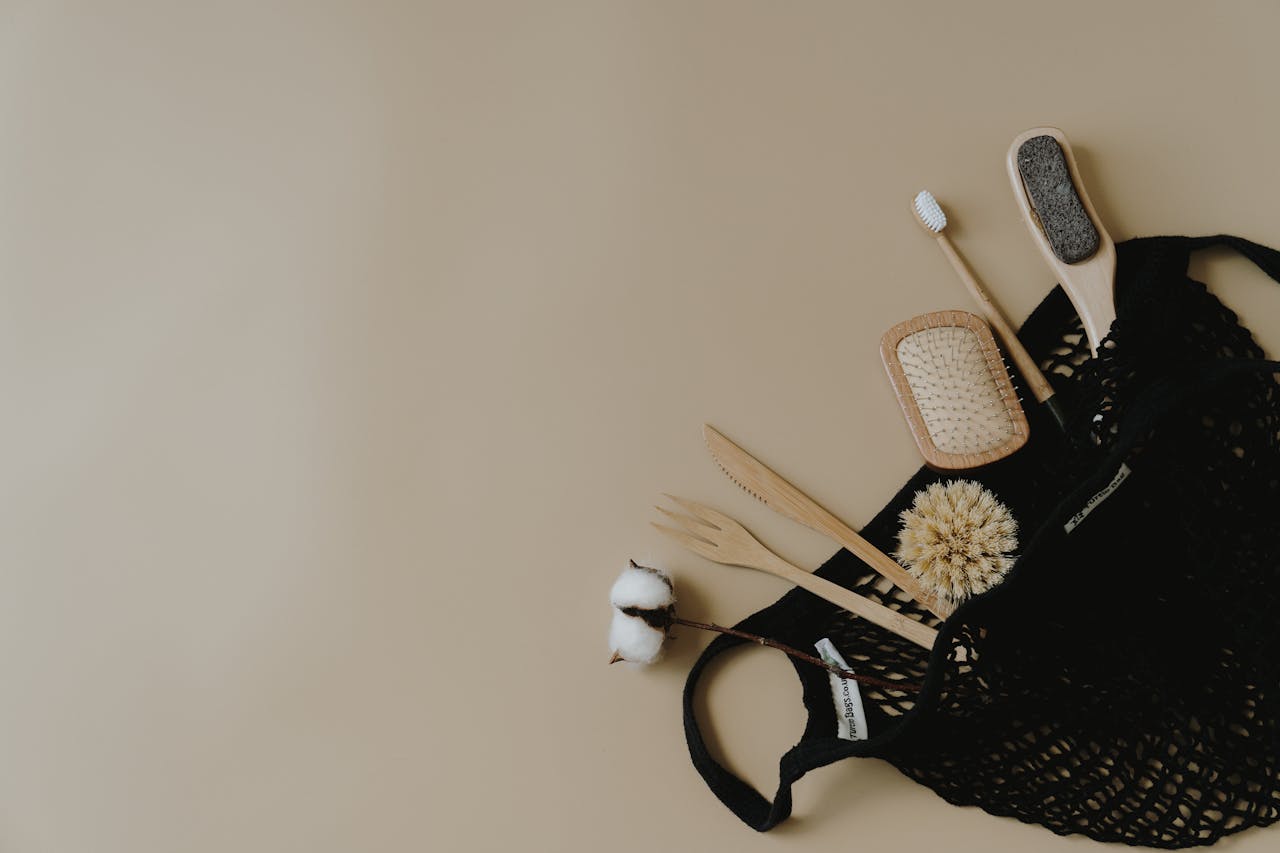 Home Flat lay of zero waste personal care items in a mesh bag on a neutral background.
